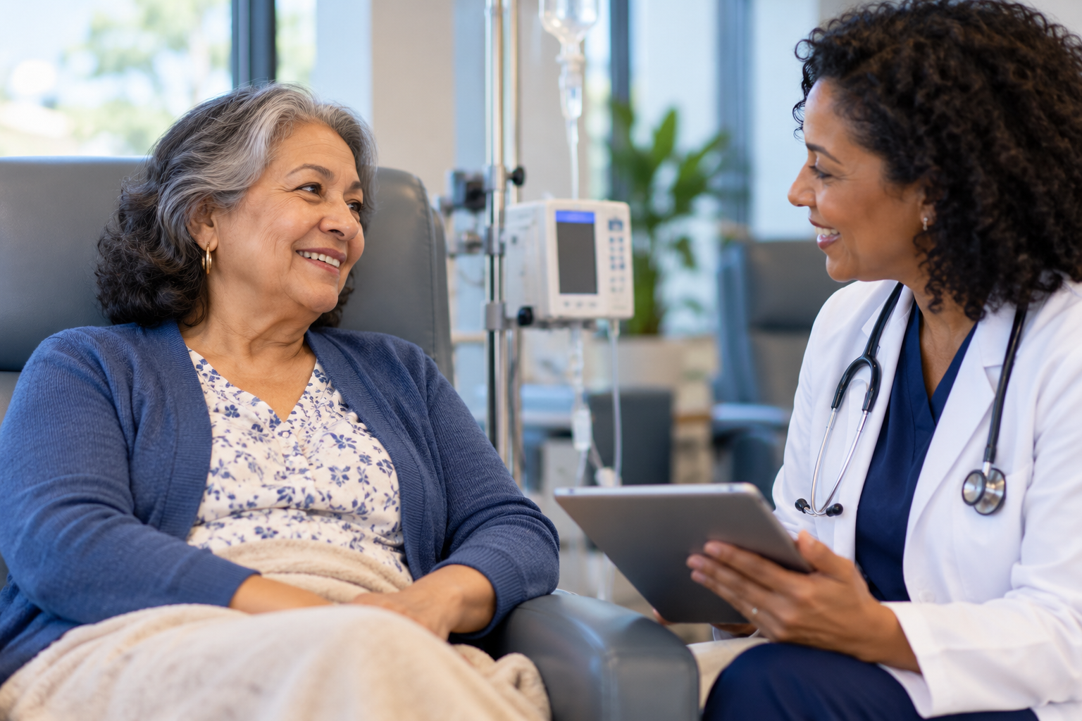 Older Medicare beneficiary talking with a clinician during an infusion treatment